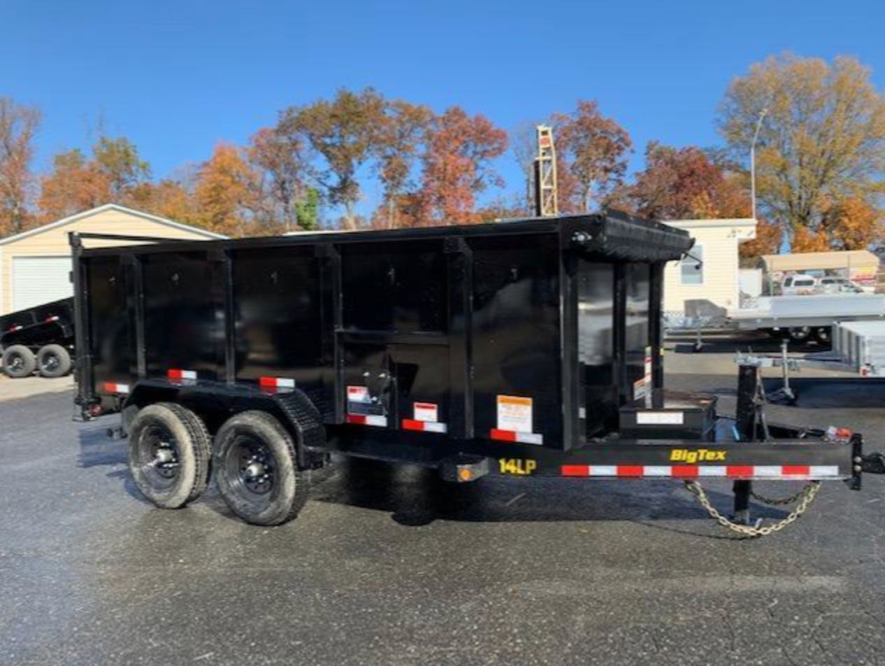 Black dump trailer raised to unload debris for hauling and cleanout projects